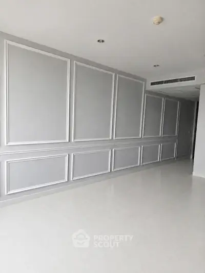 Spacious modern interior with elegant wall paneling and sleek flooring, perfect for customization.