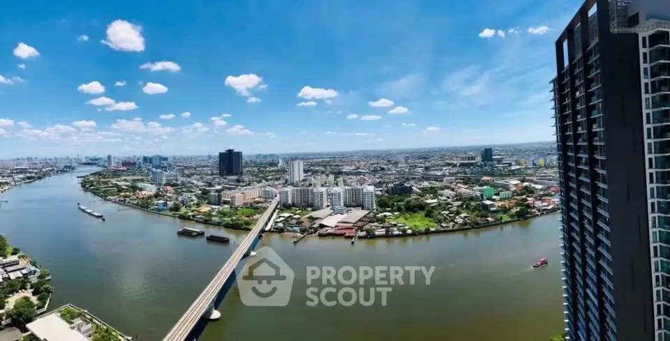 Stunning panoramic cityscape view from high-rise building overlooking river and skyline.