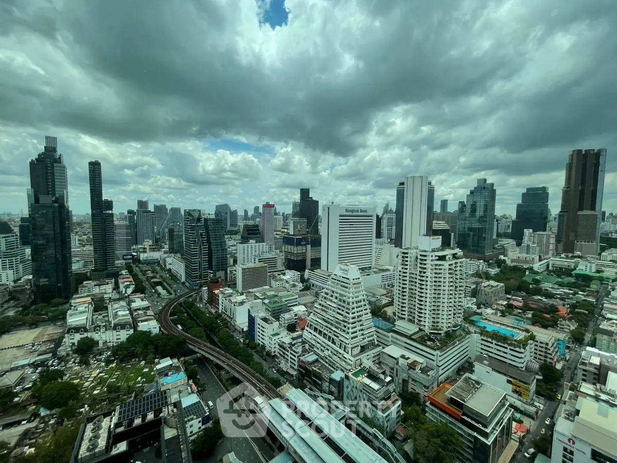 Stunning cityscape view showcasing modern skyscrapers and urban skyline under dramatic clouds.
