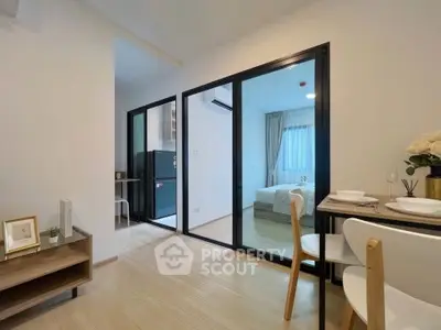 Modern apartment interior with open layout, featuring a cozy bedroom and dining area with elegant decor.