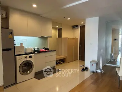 Modern apartment kitchen with washing machine and sleek cabinetry