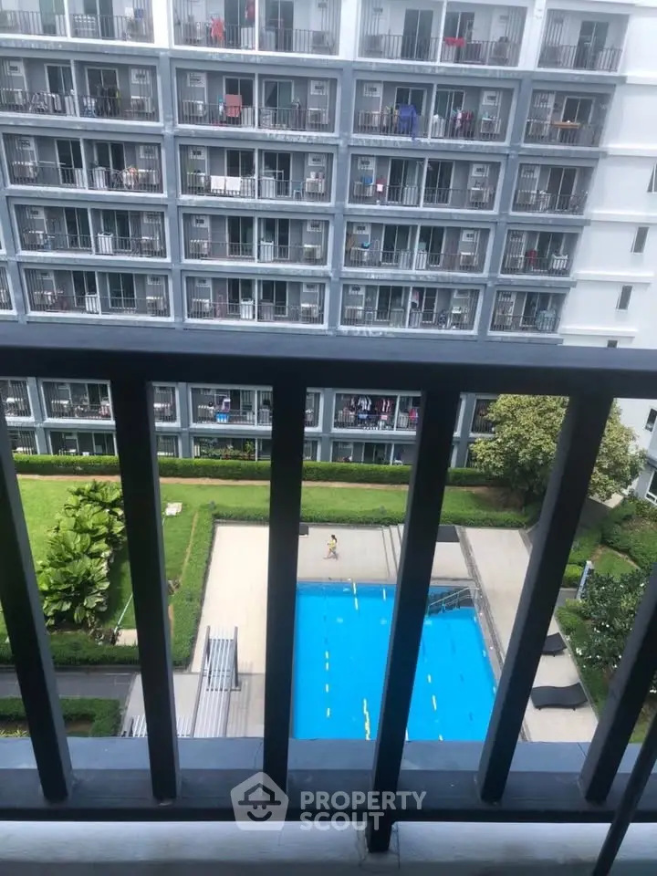 Modern apartment building with pool view from balcony, perfect for urban living.