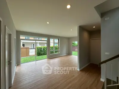 Spacious modern living room with large windows and garden view