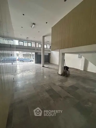 Spacious commercial space with large windows and high ceilings, ideal for retail or office use.