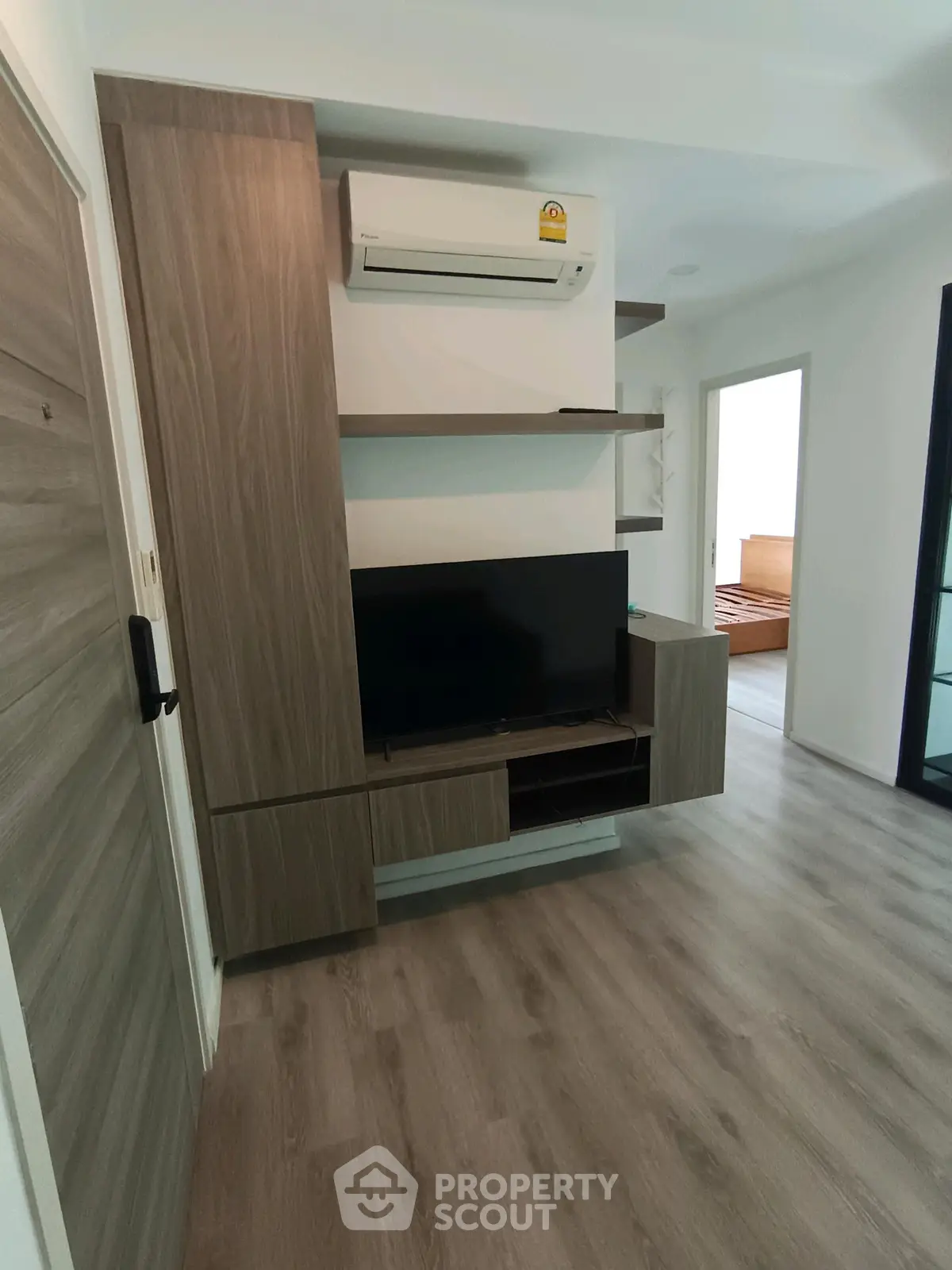 Modern living room with sleek wooden TV unit and air conditioning