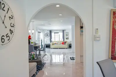 Spacious open-plan living room with modern decor and elegant archway