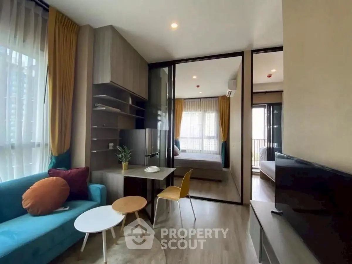 Modern living room with stylish decor and large windows in a contemporary apartment.
