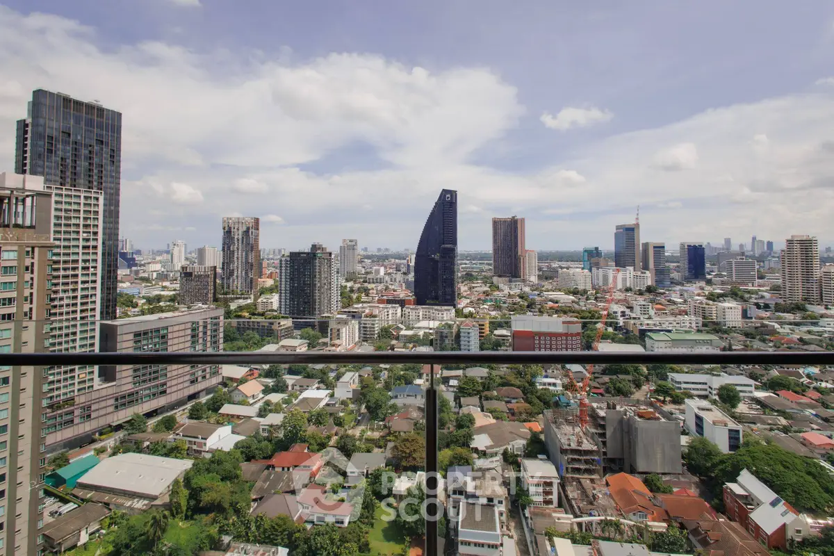 Stunning cityscape view from a high-rise balcony showcasing urban skyline and modern architecture.