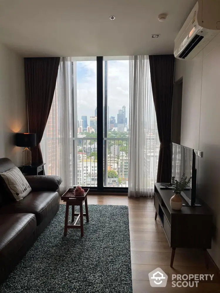 Modern living room with city view, stylish furniture, and natural light.