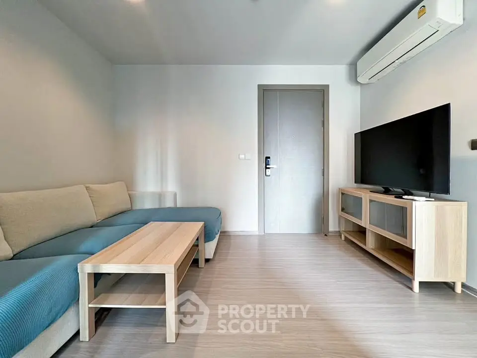 Modern living room with sleek furniture and air conditioning, perfect for relaxation and entertainment.