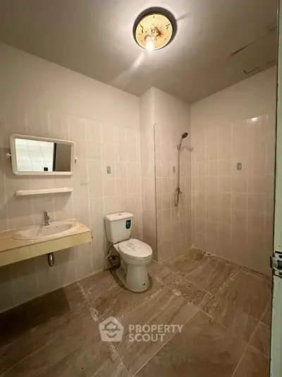 Spacious bathroom with modern fixtures and tiled flooring