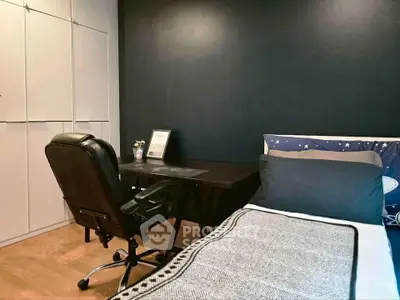 Cozy bedroom with sleek black accent wall and modern workspace