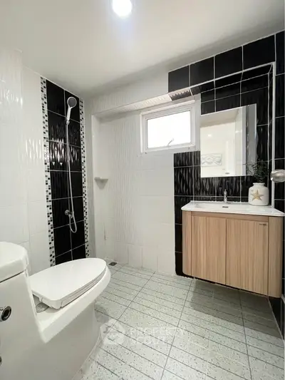 Modern bathroom with sleek black and white tiles and stylish vanity