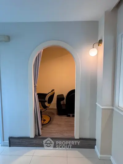 Cozy interior space with archway and modern seating, perfect for relaxation or small gatherings.