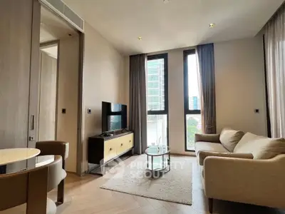 Modern living room with stylish furniture and large windows offering city views.