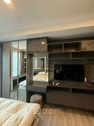 Modern bedroom with sleek TV unit and stylish decor