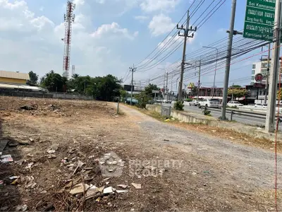 Vacant land plot with road access, ideal for development in bustling urban area.