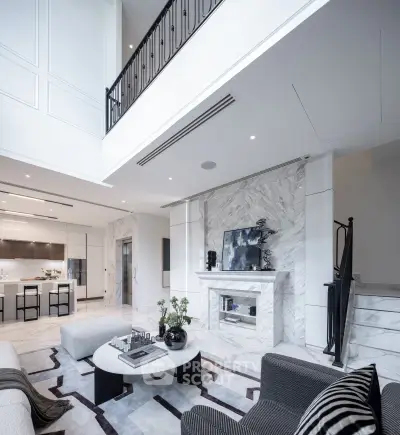 Luxurious modern living room with high ceilings and elegant marble fireplace