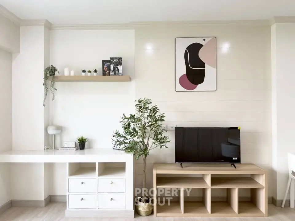 Modern living room with stylish decor, TV unit, and wall art, perfect for contemporary urban living.