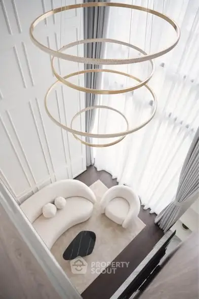 Luxurious modern living room with high ceilings and elegant chandelier