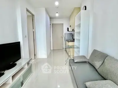 Modern living room with sleek furniture and bright lighting in a contemporary apartment.