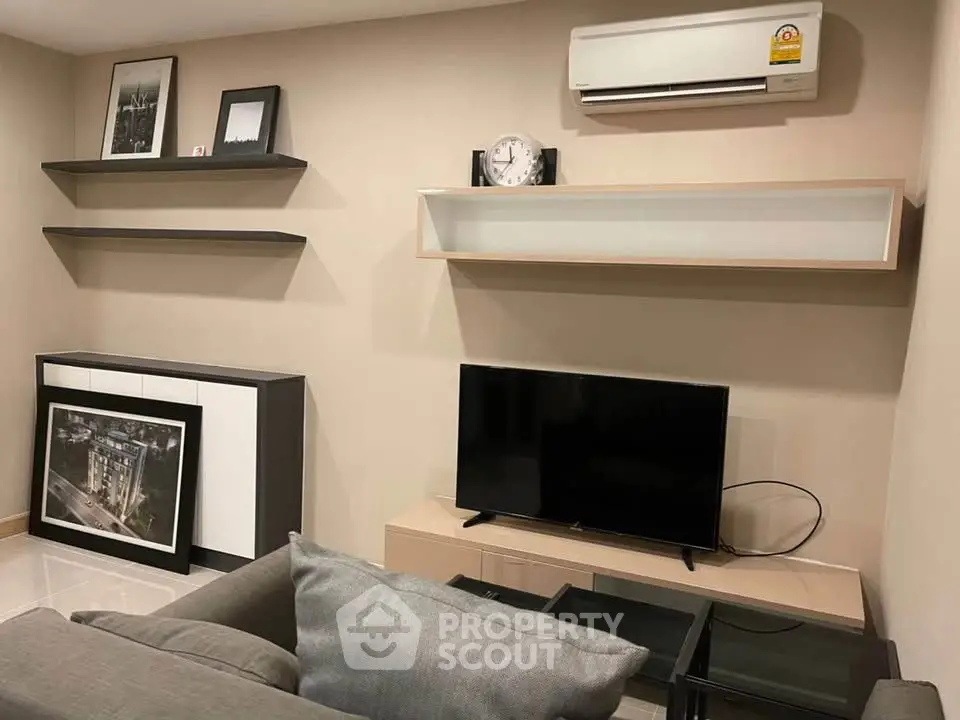 Modern living room with sleek furniture and wall-mounted air conditioner