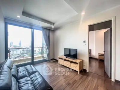 Modern living room with city view, featuring sleek leather sofa and wooden TV stand, perfect for urban living.