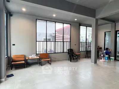 Spacious modern interior with large windows and minimalist decor