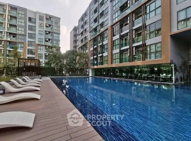 Luxurious apartment complex with stunning pool and modern architecture.