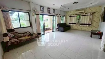 Spacious living room with large windows and elegant furnishings