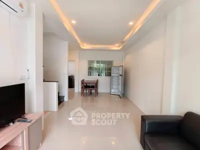 Spacious living room with modern furniture and sleek design, perfect for comfortable living.