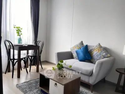 Charming living room with cozy sofa and dining area, perfect for relaxation and entertaining.