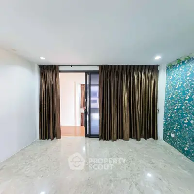 Spacious living room with elegant curtains and marble flooring in modern apartment.