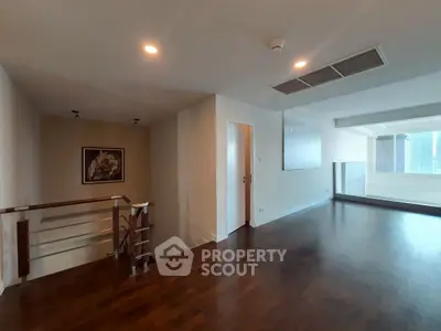 Spacious modern living room with wooden flooring and large windows