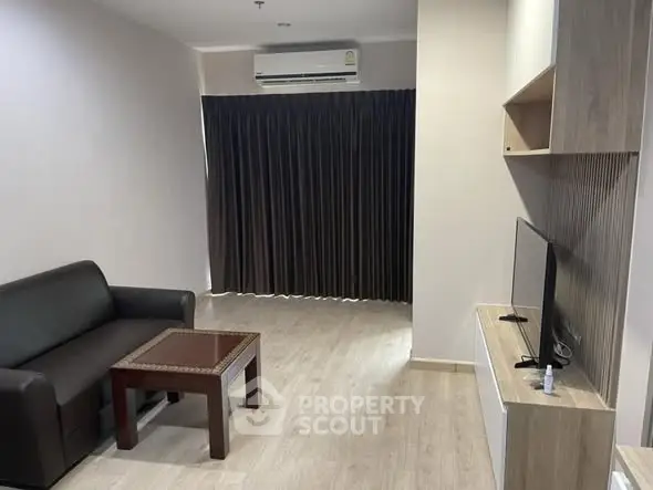 Modern living room with sleek furniture and wooden flooring