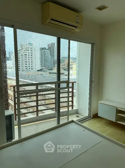 Modern bedroom with city view and air conditioning in urban apartment