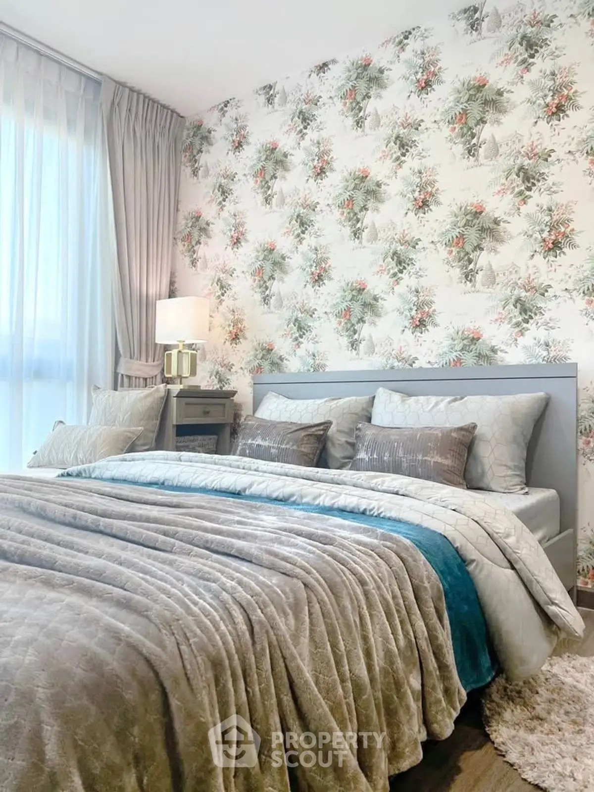 Luxurious bedroom with elegant floral wallpaper and plush bedding