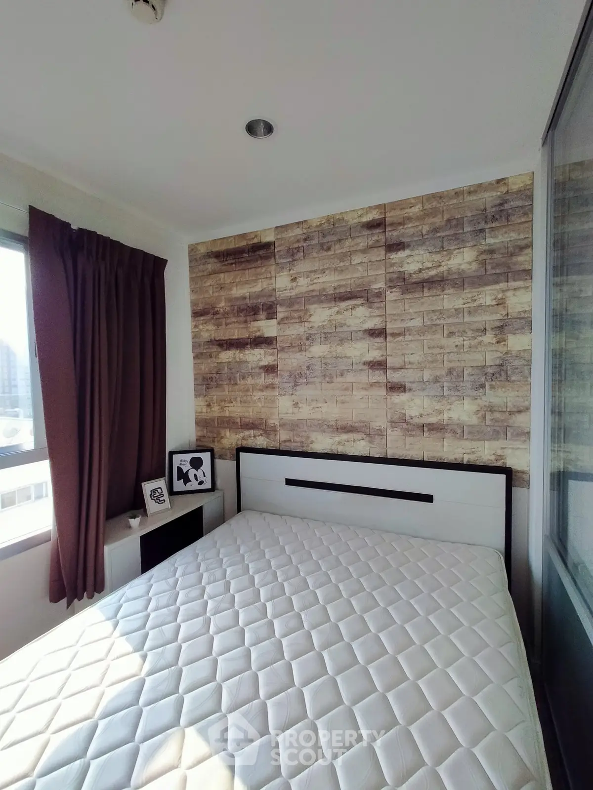 Cozy bedroom with modern decor and large window for natural light