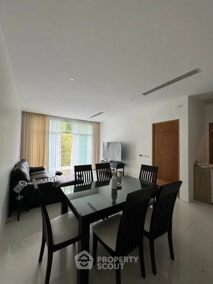 Spacious modern living room with dining area and large windows