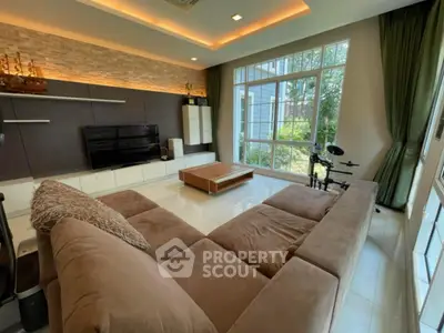 Spacious living room with modern decor and large windows for natural light