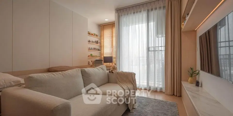 Cozy living room with modern sofa and large window offering natural light.