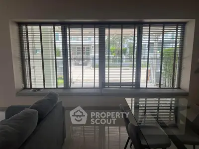 Modern living room with large window and stylish furniture