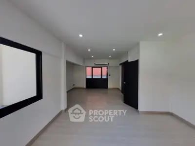 Spacious modern living room with large windows and sleek flooring