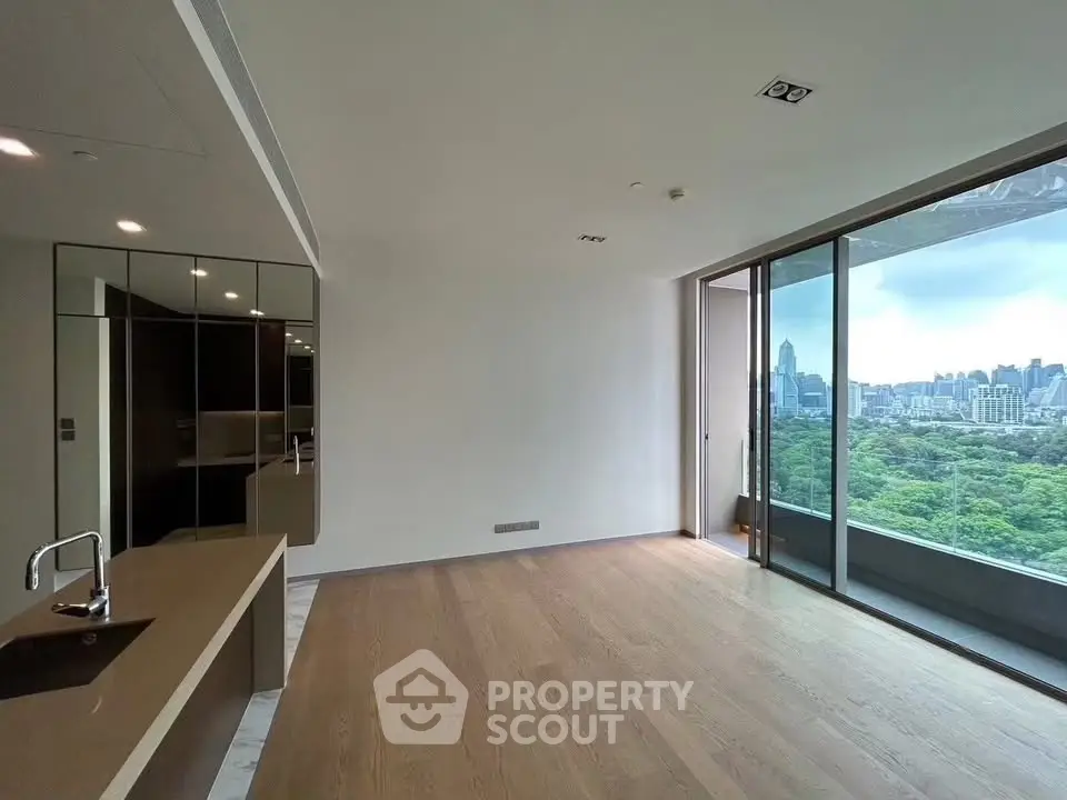 Spacious modern living room with stunning cityscape view and sleek kitchen design.