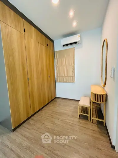 Modern bedroom with wooden wardrobe and stylish vanity set
