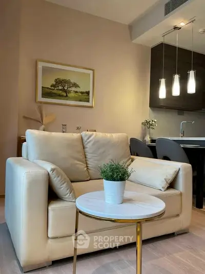 Elegant living room with beige sofa and modern kitchen in open layout