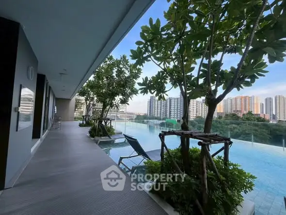 Luxurious rooftop pool with city skyline view and lush greenery