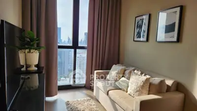 Modern living room with city view, cozy sofa, and stylish decor in high-rise apartment.