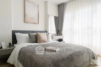 Elegant bedroom with modern decor and large window for natural light