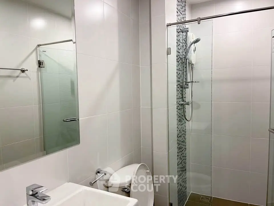 Modern bathroom with glass shower and sleek fixtures